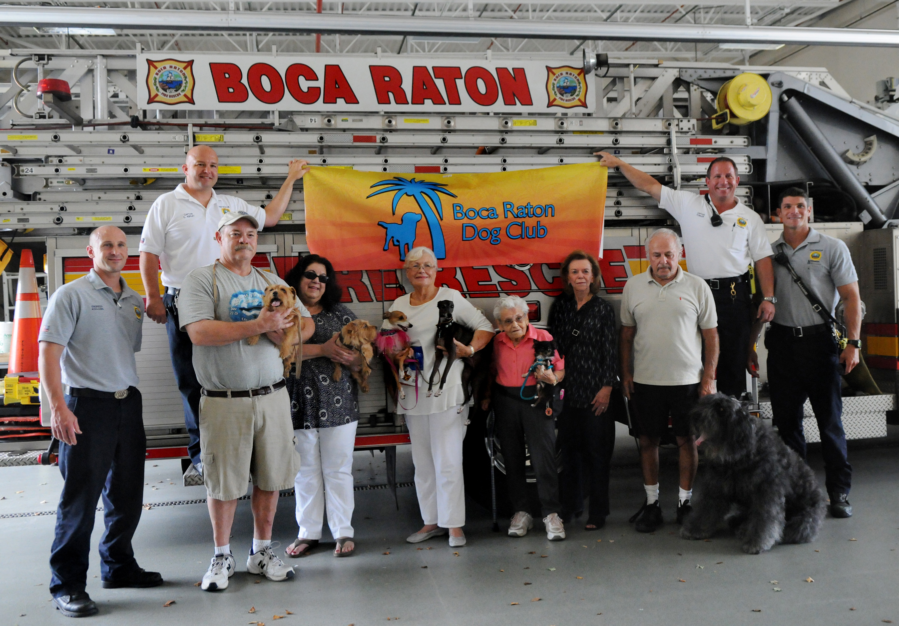 FPG-BRF-FIREDOG-0812a FPG photo/Marta Mikulan Martin 7/31/15 July 31 2015: The Boca Raton Dog Club was donating pet oxygen mask to Boca Raton Fire Rescue. The club is doing with profits from their recent American Kennel Club Dog Show.. At Fire Station #5, members of the club and squad members are sharing a photo to celebrate the donation.